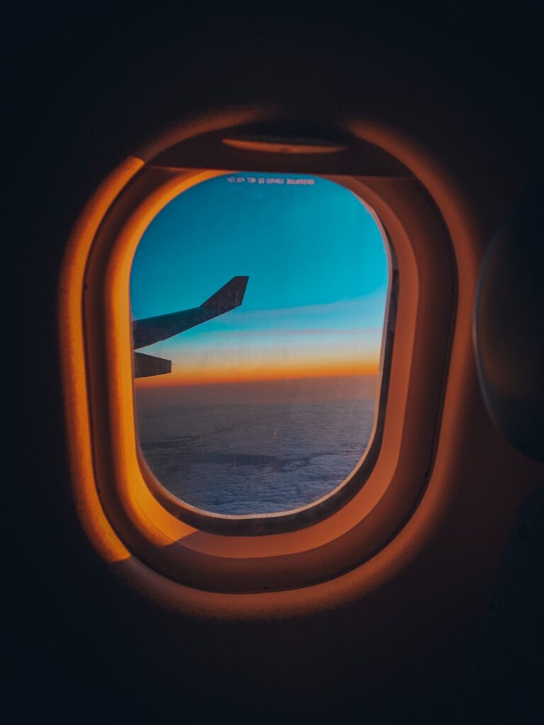 sunset-through-airplane-window-flight-shame-offset